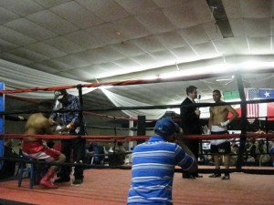 Oscar Tovar Jr. celebrating his win, while Roberto Perez recovers on the stool. 